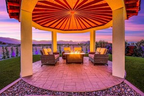 Elegant outdoor dining under a dramatic dome-style gazebo, ideal for evening gatherings.