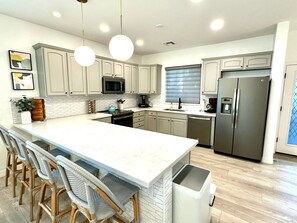 Large Kitchen with breakfast bar, all appliances, utensils and cooking supplies.