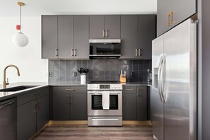 Fully Stocked Kitchen with Modern Appliances and Ample Storage
