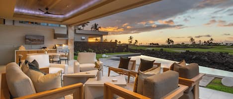 Lounge in the living area that opens to the expansive lanai with wall to wall sliders.
