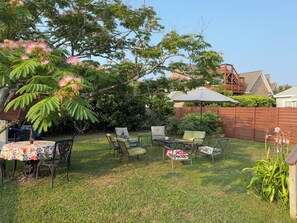 Large fenced back yard with outdoor furniture