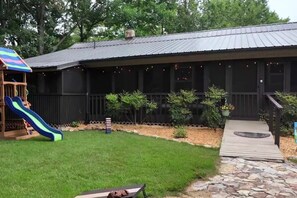 Relax on the porch while the kids play in the beautiful yard on the slide and swings or toss the bean bags.