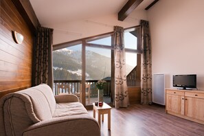 Sink into the comfortable sofa and watch TV (for FREE for short stays!)