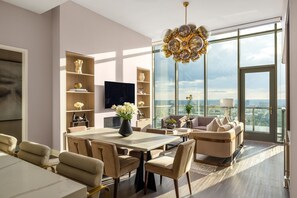6-seater dining table and living room featuring a 65" 4K UHD TV