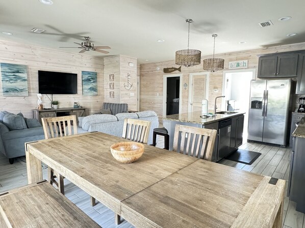 This home has an open floor plan that connects the living room, dining room, and kitchen.