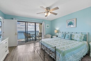 Primary bedroom features a king bed and balcony access.