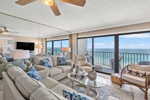 Bright living room with ocean views, cozy seating, and coastal decor.