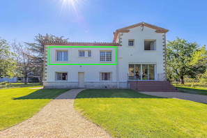 The apartment bedrooms, overlooking the garden, pool, and river