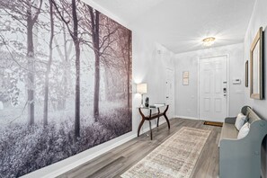 Spacious, hallway area with seating. Ideal for little ones to put on shoes