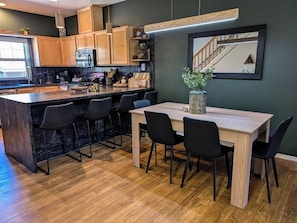 Large breakfast bar with 4 comfy stools and dining table with 6 chairs.