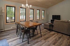 Large windows throughout offer stunning views of the tranquil outdoors.