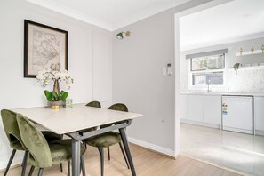 The dining area, located downstairs, includes a four-seater table to enjoy meals together. 
