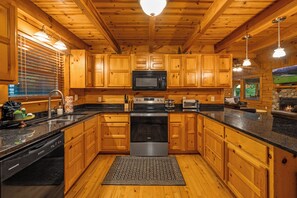 Spacious Kitchen with Large Peninsula. Cook and gather effortlessly in our well-appointed kitchen, which includes a generous peninsula for easy meal preparation and socializing.