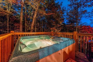 Relax in our bubbling hot tub at dusk. Unwind and soak in the tranquil evening ambiance at our cozy Smoky Mountains cabin. The perfect spot to end your day.