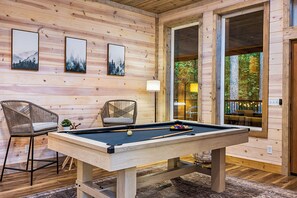 Game Room: Challenge friends to a fun game of pool while enjoying serene woodland views!