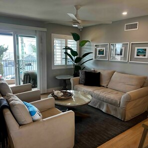 Living room with swivel chairs to shift one's focus to TV,  kitchen, or sofa.