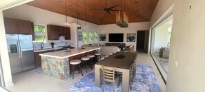 Looking into the kitchen and dining area from the pool side patio