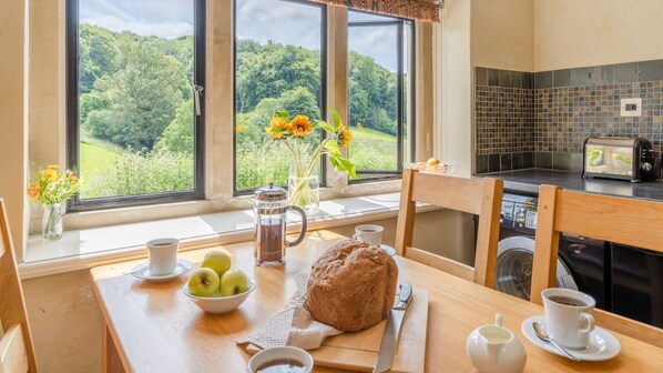 A light-soaked dining area with beautiful valley views