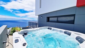 The luxurious 6+ person jacuzzi at Azure Serenity Villa offers a relaxing experience with stunning ocean and mountain views in Gaula, Santa Cruz Madeira. Perfect for a serene getaway. #jacuzzi #oceanview