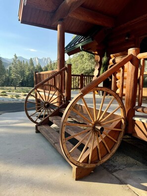 Step into rustic charm with this beautifully crafted log home entrance, featuring unique wagon wheel stairs and breathtaking views of The Needles mountain range that greet you at every turn.