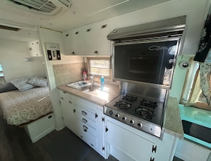 The kitchen includes a stove and oven, perfect for cooking.