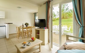 Find peace and relaxation with your close friends and family in this stunning open-concept living room featuring natural decor.