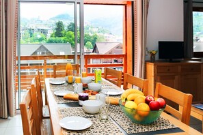 Enjoy a meal at the grand dining table with seating.