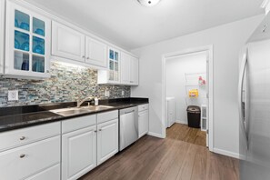 Laundry room at the end of kitchen