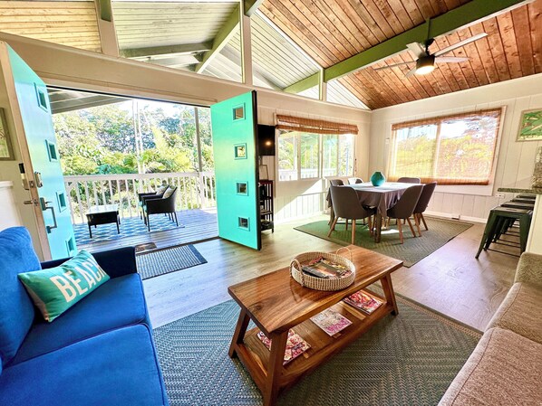 The lanai seamlessly leads into the vaulted ceiling, open-beamed Great Room.