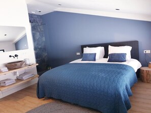 Bedroom 2: with sweeping meadow views, a 180×200 double bed, and a private ensuite shower. Wake up with nature right outside your window.