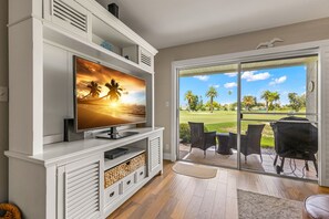 Enjoy watching TV from the cozy living room, with the patio door just behind it offering easy access to fresh air and scenic views