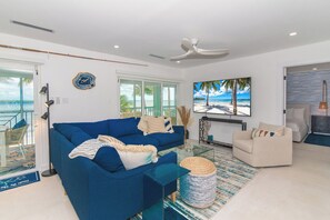 Living area with HD television, sound bar, and modern furnishings.