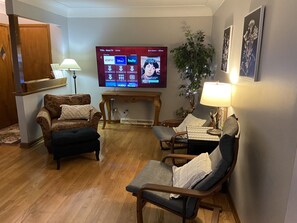 Living Room with large screen Roku TV. Includes Disney+, Hulu and ESPN+