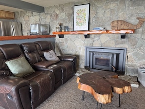 Living room section with wood burning fireplace