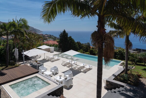 The Exceptional Swimming Pool Area Of Villa Bellissima By Ourmadeira With Infinty Pool And Raised Hot Tub With Views Of The Sea