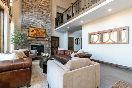 Open concept Livingroom with enormous ceilings, fireplace, TV and sound system