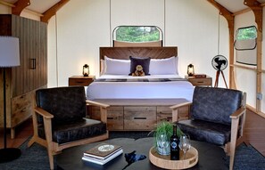 Cozy glamping interior with plush seating and a warm ambiance, perfect for relaxation.