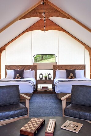 Cozy glamping interior with plush seating and ample natural light, perfect for unwinding.