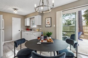 Gather around the dining table for home-cooked meals, game nights, or morning coffee in this welcoming and light-filled space.
