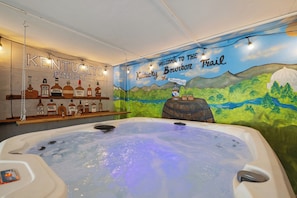 Unwind in our 7-person hot tub against a mural of KY views and bourbon bottles. 