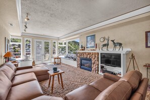 Living room: Smart TV with basic cable, gas fireplace, central heat, window A/C unit and portable fans in summer