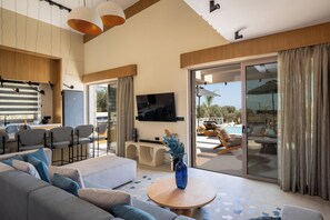 The living room features a 55” TV, a Samsung sound bar, and direct outdoor access