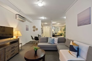 A cozy living area with a TWO 3-seater sofa beds that folds out to doubles.