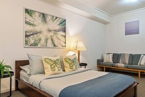 A bedroom area with a queen sized bed & plush pillows.