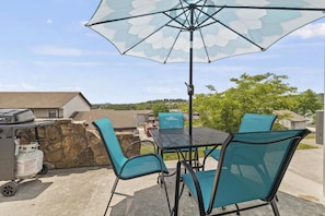 Dining area on back patio with a lake view
