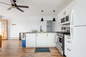 Brand new full kitchen featuring gas range, over the range microwave, dishwasher and pantry. 