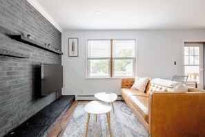 55in HDTV with streaming, wood burning fireplace and leather sofa. 