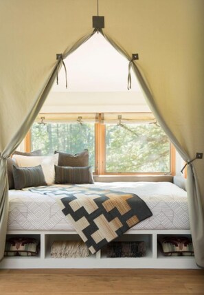 Enjoy a restful night in this quaint and charming bedroom with beautiful natural light and rustic elegance.