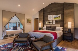 Indulge in comfort with this spacious and stylishly decorated bedroom, featuring modern touches and cozy accents.