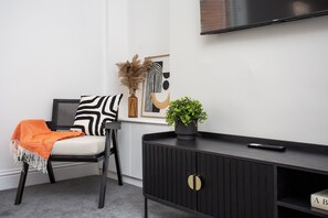 The room is adorned with chic décor and a side couch for the comfort of guest. 